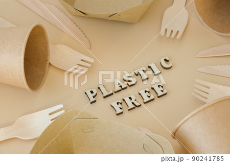 PLASTIC FREE text around Eco friendly, disposable, recyclable, compostable tableware. Paper food boxes, dishes on neutral beige background. Sustainable lifestyle concept. Flat lay 90241785