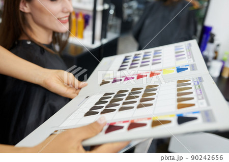 Hairstylist Giving Customer Hair Color Chart 90242656