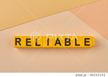 The word reliable written on yellow cubes close up. The word reliable written on yellow cubes close up. 90243143