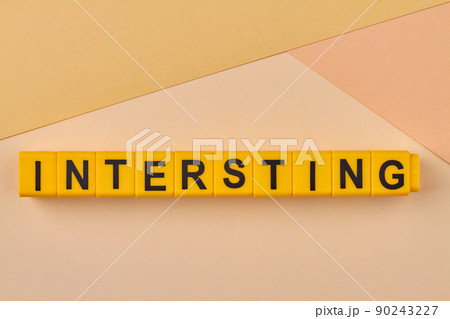 Creative flat lay from plastic cubes with inscription interesting. 90243227