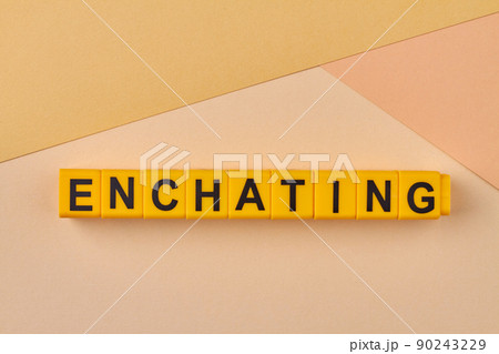 Enchanting word written on alphabet blocks on light background close up. 90243229