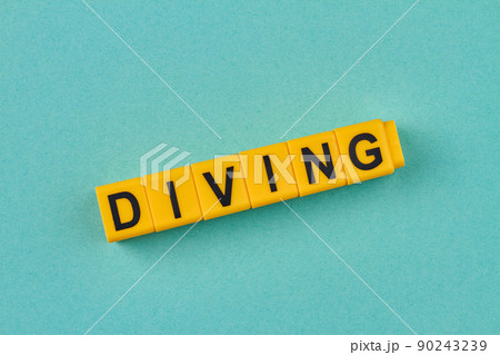 The word diving written on yellow cubes close up. 90243239