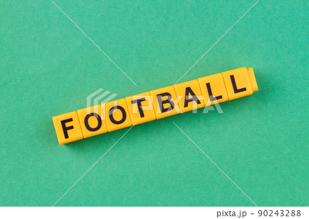 Yellow cubes with inscription football on green background. Yellow cubes with inscription football on green background. 90243288