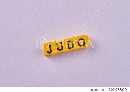 The word judo written on yellow cubes against color background. 90243300