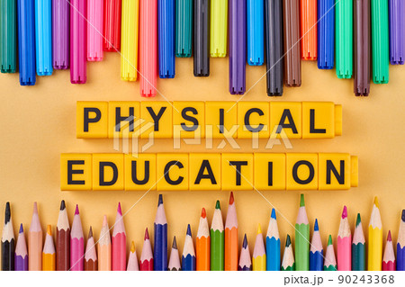 The inscription physical education written on yellow cubes against color background. The inscription physical education written on yellow cubes against color background. 90243368