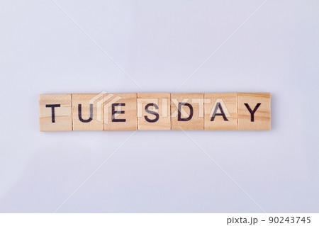 Tuesday word written with vintage wooden cubes and black letters. Tuesday word written with vintage wooden cubes and black letters. 90243745