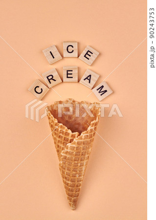 Waffle cone and wooden cubes with inscription ice-cream. Waffle cone and wooden cubes with inscription ice-cream. 90243753