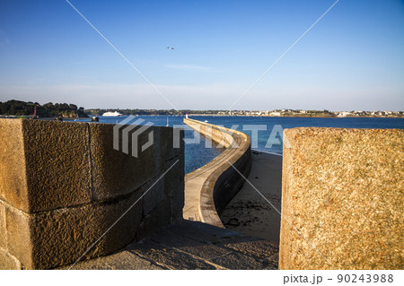 Saint-Malo lighthouse and pier view from the city fortifications, Brittany, France 90243988
