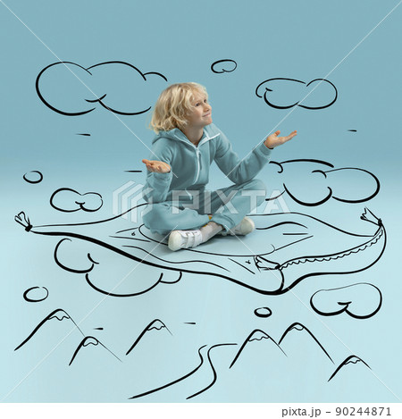 Cute kid, little boy sitting and dreaming about trips, flights an adventures isolated on blue background with pencil sketch and drawings. Concept of ideas, imagination Cute kid, little boy sitting and dreaming about trips, flights an adventures isolated on blue background with pencil sketch and drawings. Concept of ideas, imagination 90244871