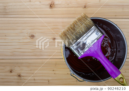 Special protective oil with brush for covering larch floors. Wooden larch floor before painted by special protective oil. Special protective oil with brush for covering larch floors. Wooden larch floor before painted by special protective oil. 90246210