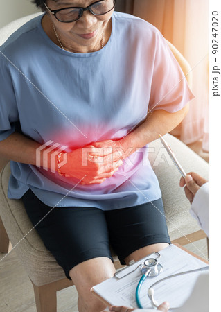 Abdominal pain in elder senior mature aging woman with stomachache illness from stomach cancer, irritable bowel syndrome, Indigestion, Diarrhea or GERD (gastro-esophageal reflux disease) 90247020