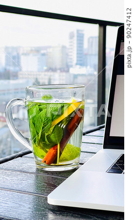 Hot tea with cinnamon bark and green mint leaves Hot tea with cinnamon bark and green mint leaves 90247412