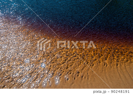 Peat-colored shallow water of river running into lake Ladoga 90248191
