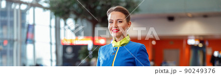 Joyful woman stewardess standing in airport terminal 90249376