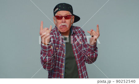 Overjoyed happy man showing rock n roll gesture by hands, cool sign, shouting yeah with crazy face Overjoyed happy man showing rock n roll gesture by hands, cool sign, shouting yeah with crazy face 90252540