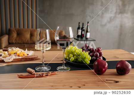 Wine glasses with appetizers on table 90252630