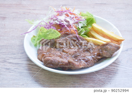grilled black pepper pork steak with french fries and salad dressing mayonnaise on plate grilled black pepper pork steak with french fries and salad dressing mayonnaise on plate 90252994