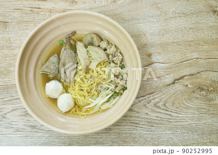 boiled Chinese yellow egg noodles with entrails and fish ball in soup on bowl boiled Chinese yellow egg noodles with entrails and fish ball in soup on bowl 90252995