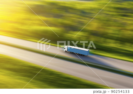 Aerial view of a truck on the highway at sunset. Shipping and delivery. 90254133