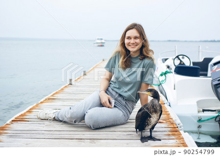 Beautiful young woman near the sea. Beautiful young woman near the sea. 90254799