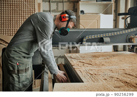 Worker Wearing Safety Gear in Shop 90256299