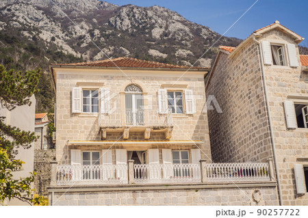 Scenic panorama view of the historic town of Perast at famous Bay of Kotor with blooming flowers on a beautiful sunny day with blue sky and clouds in summer, Montenegro, southern Europe Scenic panorama view of the historic town of Perast at famous Bay of Kotor with blooming flowers on a beautiful sunny day with blue sky and clouds in summer, Montenegro, southern Europe 90257722