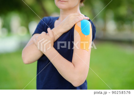 Woman with kinesio tape on her shoulder. Kinesiology, physical therapy, rehabilitation 90258576