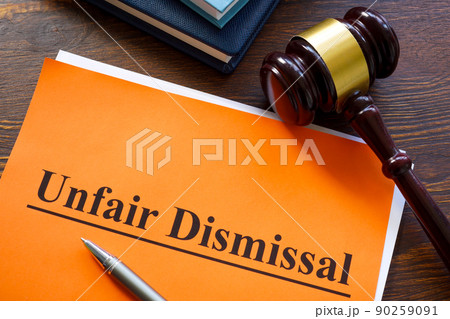Report about unfair dismissal with book on the table. 90259091