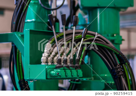 Hydraulic manual control levers of agriculture machine equipment - close up 90259415