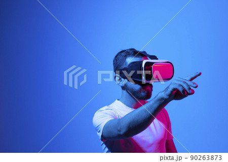 Modern architect, designer using virtual reality glasses at workplace. Designer working in augmented reality vr studio. Man working in VR goggles on a studio background. 90263873