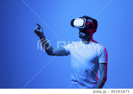 Modern architect, designer using virtual reality glasses at workplace. Designer working in augmented reality vr studio. Man working in VR goggles on a studio background. 90263875