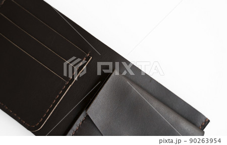 Top view of open brown empty man's black handmade genuine leather wallet with pockets for banknotes, credit cards and monets isolated on white background. Selective focus, copy space, Close up. Top view of open brown empty man's black handmade genuine leather wallet with pockets for banknotes, credit cards and monets isolated on white background. Selective focus, copy space, Close up. 90263954