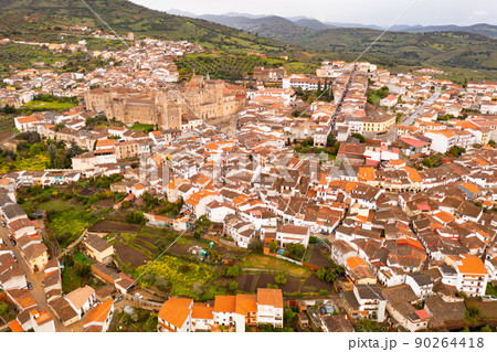 Drone view of Guadalupe with residential buildings and medieval Monastery 90264418