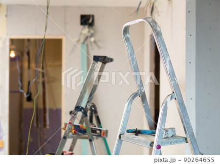 Photo of stepladders in empty apartment, reconditioning work 90264655