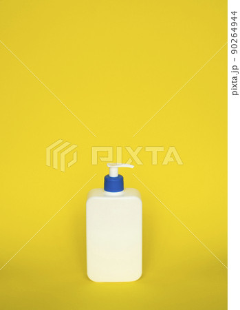 Liquid container for gel, lotion, cream, shampoo, bath foam. Cosmetic plastic bottle with blue dispenser pump on yellow background. Cosmetic packaging mockup with copy space. Liquid container for gel, lotion, cream, shampoo, bath foam. Cosmetic plastic bottle with blue dispenser pump on yellow background. Cosmetic packaging mockup with copy space. 90264944