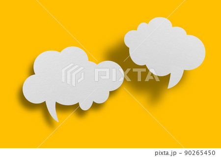 White paper in speech bubble shape set against yellow background. 90265450