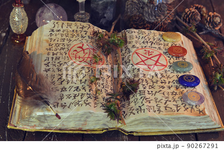 Wicca, esoteric and occult still life with vintage magic objects and grimoire on witch table altar for mystic rituals and fortune telling. Halloween and gothic concept. No foreign language. Wicca, esoteric and occult still life with vintage magic objects and grimoire on witch table altar for mystic rituals and fortune telling. Halloween and gothic concept. No foreign language. 90267291