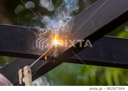 worker welding steel pipe in construction site 90267364