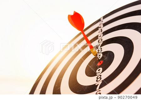 Dart arrow hit to center on bullseye of a dartboard Dart arrow hit to center on bullseye of a dartboard 90270049
