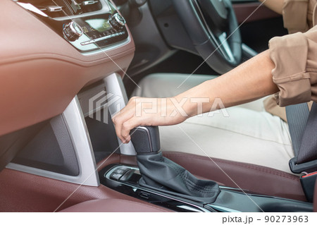 woman driver stick shift transmission a car gear, hand controlling steering wheel during vehicle moving. Journey, trip and safety Transportation concepts woman driver stick shift transmission a car gear, hand controlling steering wheel during vehicle moving. Journey, trip and safety Transportation concepts 90273963