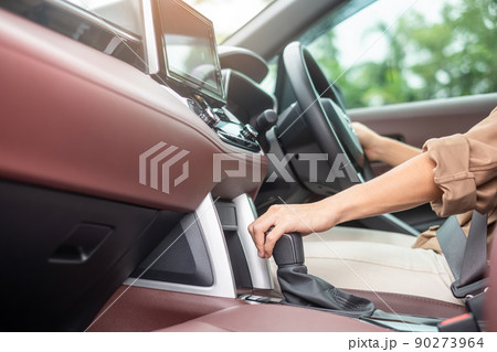 woman driver stick shift transmission a car gear, hand controlling steering wheel during vehicle moving. Journey, trip and safety Transportation concepts woman driver stick shift transmission a car gear, hand controlling steering wheel during vehicle moving. Journey, trip and safety Transportation concepts 90273964