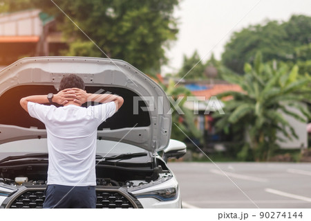man driver standing near a problem car. Breakdown or broken car on road. Vehicle Insurance, maintenance and service concept 90274144