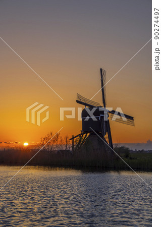 Sunset with windmill Broekmolen, Molenlanden - Nieuwpoort, The Netherlands Sunset with windmill Broekmolen, Molenlanden - Nieuwpoort, The Netherlands 90274497