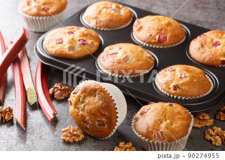 Homemade sweet muffins with rhubarb and walnuts close-up in a baking dish. horizontal 90274955