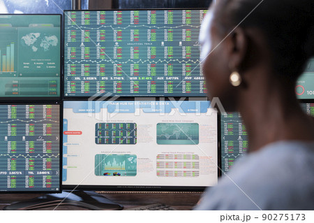 Close up shot of forex stock market investor sitting in front of multi display workstation. Business company financial advisor reviewing hedge fund value growth while analyzing real time data. 90275173