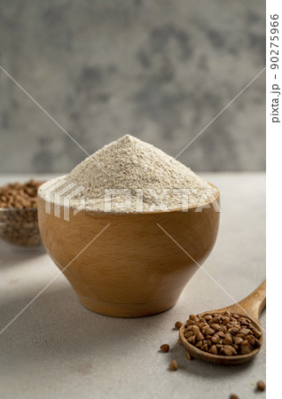Buckwheat flour in wooden bowl, buckwheat grain, gluten free flour concept. Healthy food Buckwheat flour in wooden bowl, buckwheat grain, gluten free flour concept. Healthy food 90275966