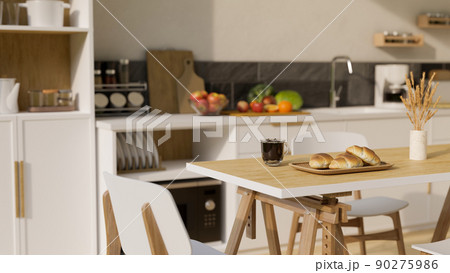 Minimal wooden dining table over blurred modern bright and clean kitchen cooking space Minimal wooden dining table over blurred modern bright and clean kitchen cooking space 90275986