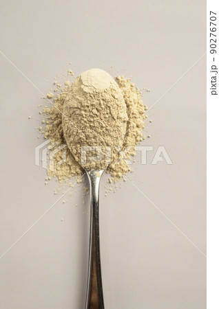 Heap of protein powder and a spoon with glass of water. Food supplements Heap of protein powder and a spoon with glass of water. Food supplements 90276707
