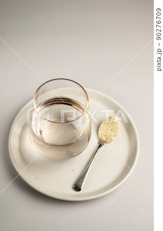 Protein powder and a spoon with glass of water. Food supplements Protein powder and a spoon with glass of water. Food supplements 90276709