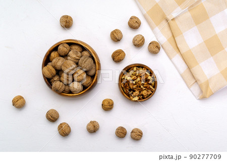 Walnut kernels on a table stone white background, flat lay. Walnut kernels on a table stone white background, flat lay. 90277709